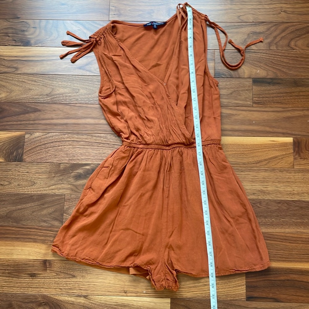 Rust romper. Worn twice. Flowy material snap at chest